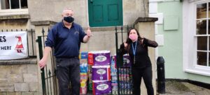 People standing beside food bank donations in Faringdon
