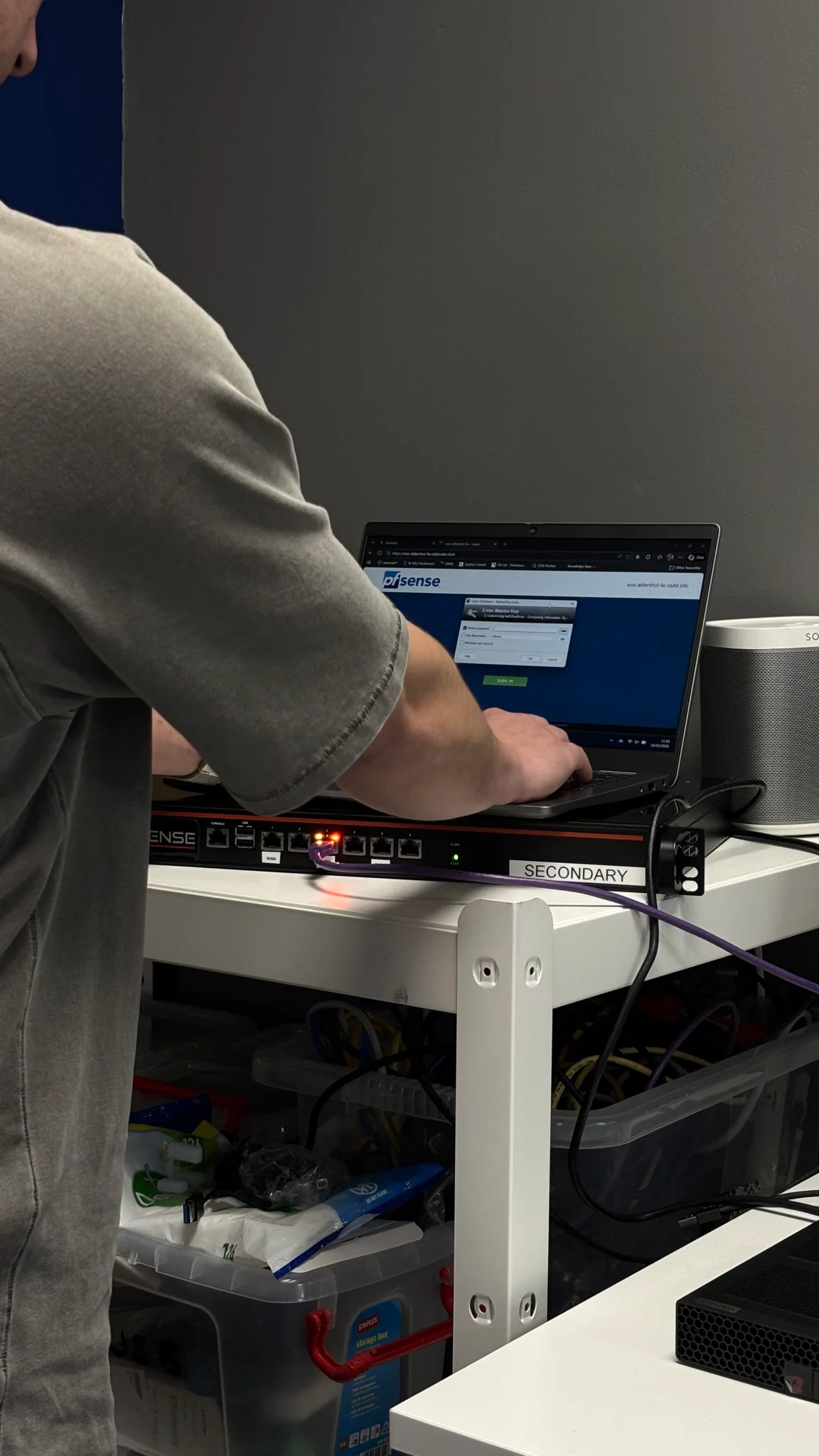 CIS technician configuring network equipment using a laptop