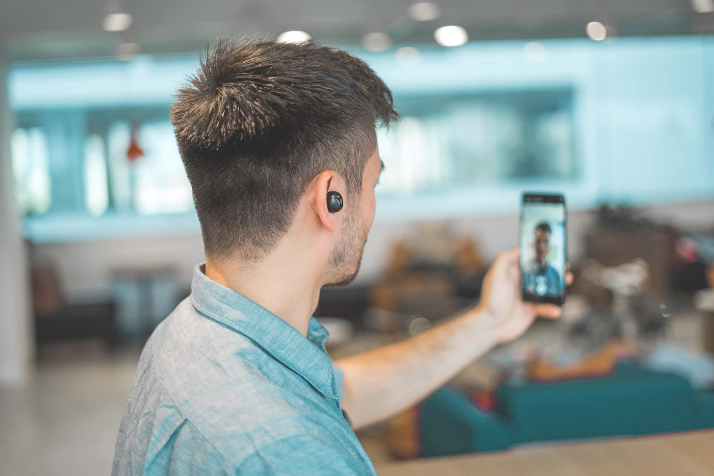 Business professional using a wireless headset for a video call