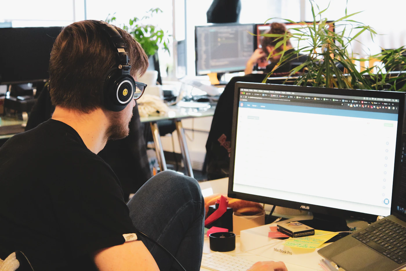 IT support specialist using a headset at a desktop workstation
